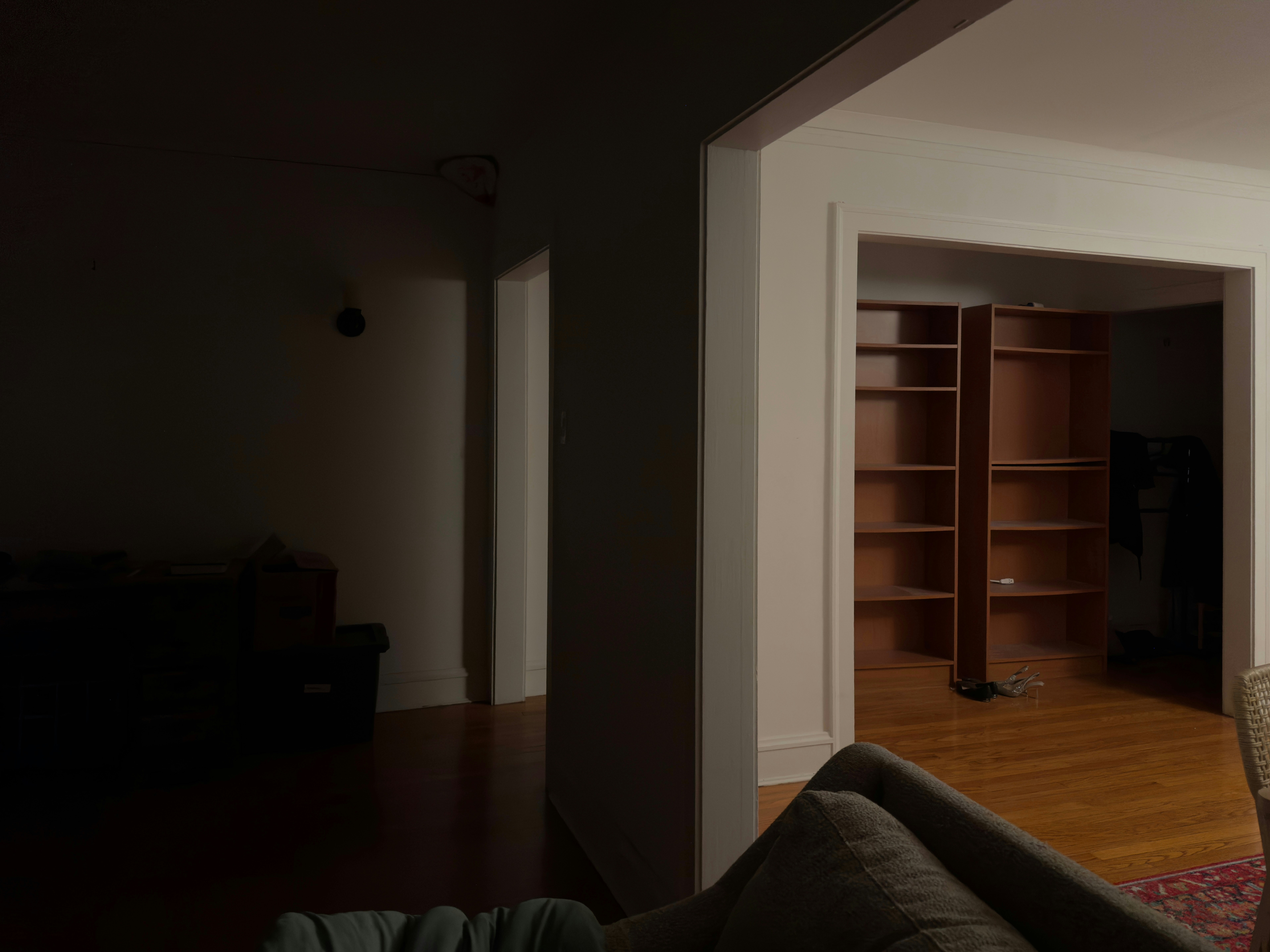 Interior view of a dimly lit room with bookshelves