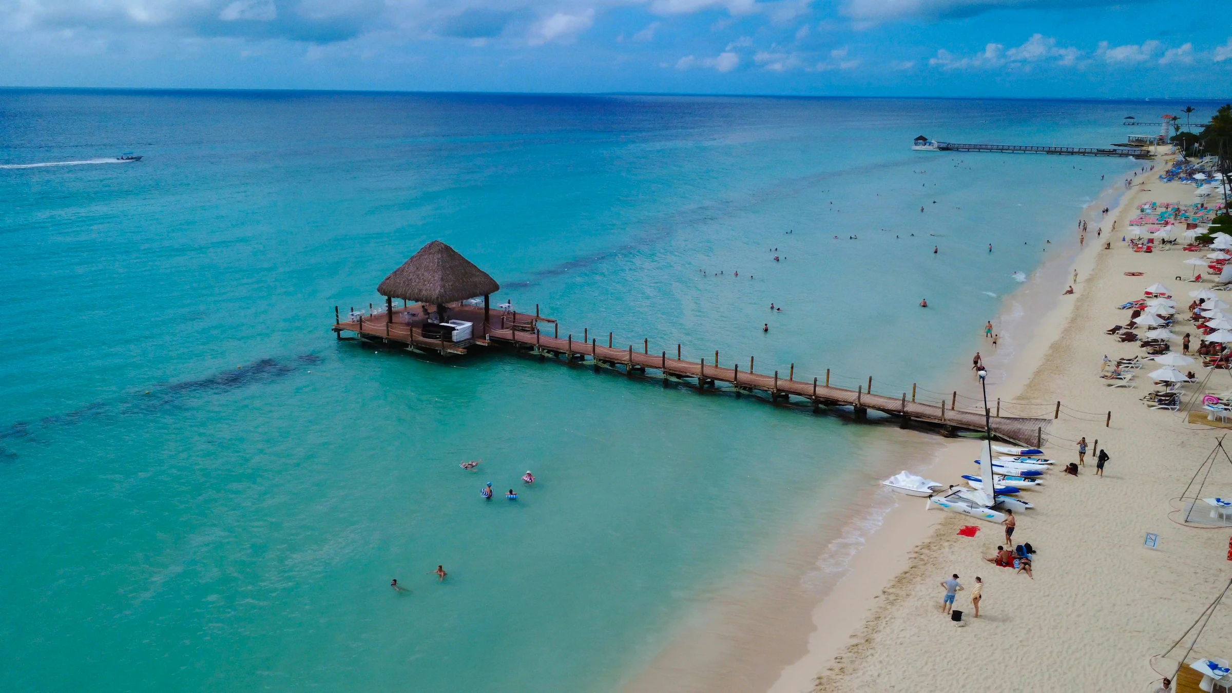 Clear Caribbean water and a quiet palm-lined beach