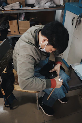 Man working on shoe repair in workshop