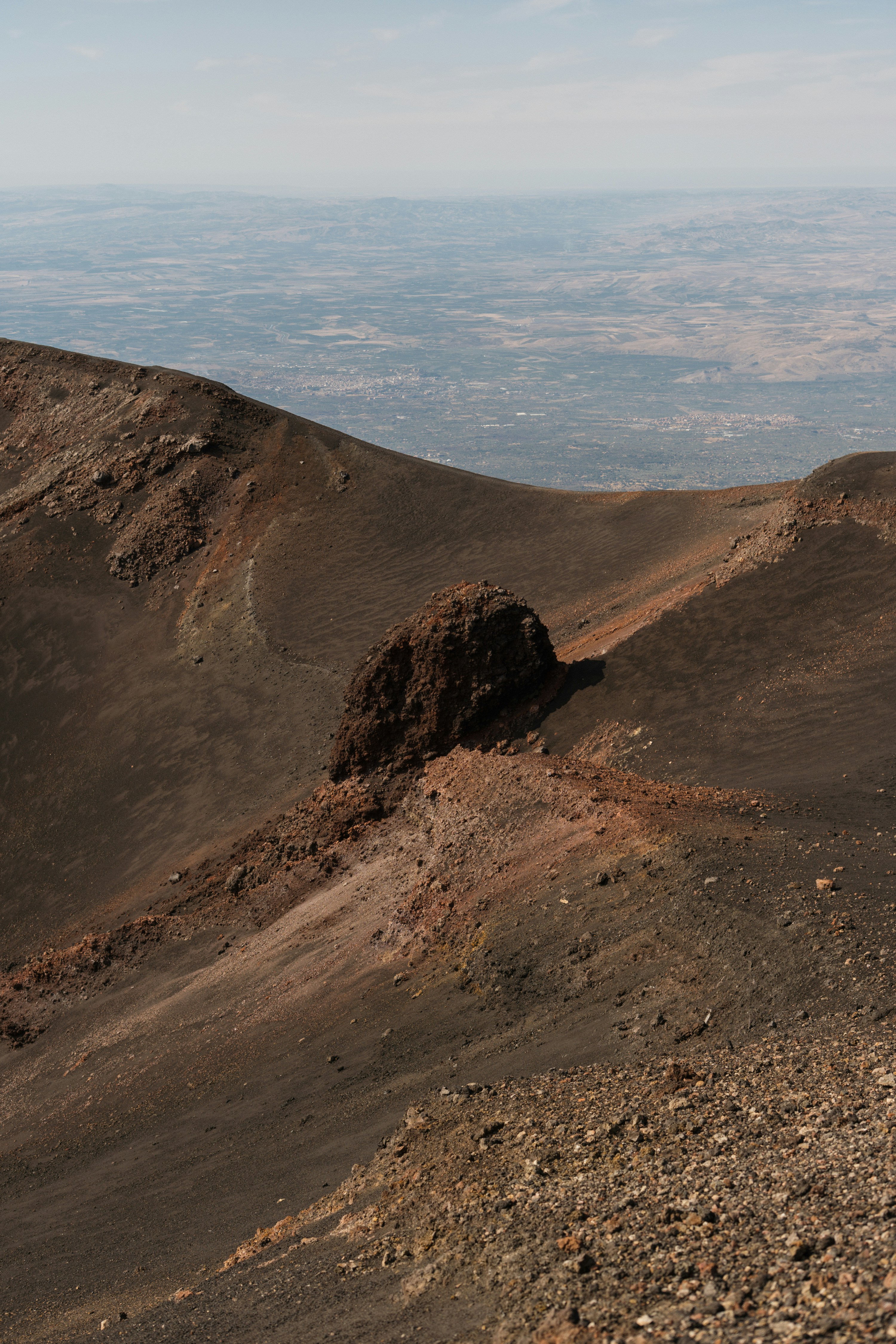 Rocky volcanic landscape with distant plains