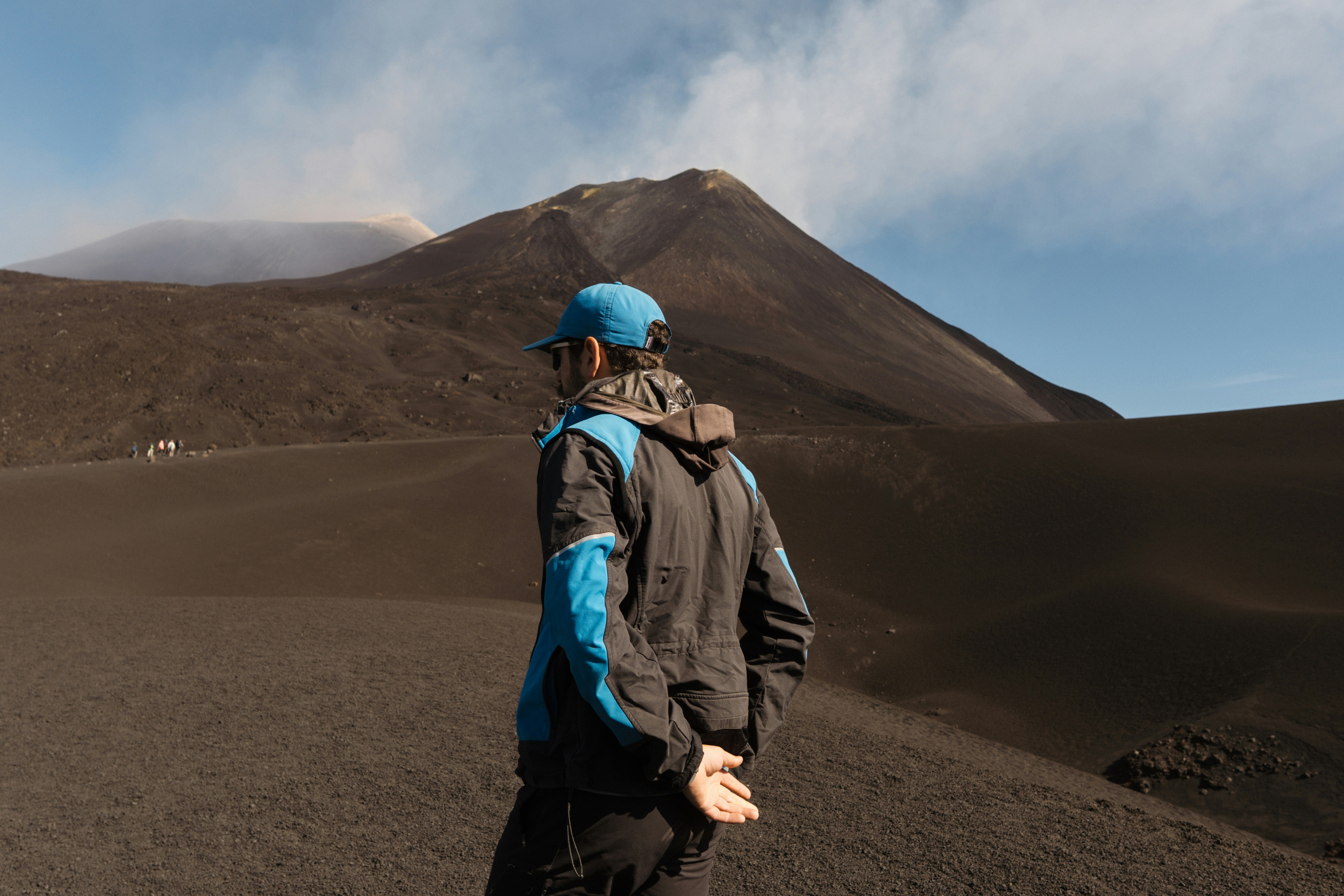 Man looking at a volcanic mountain landscape