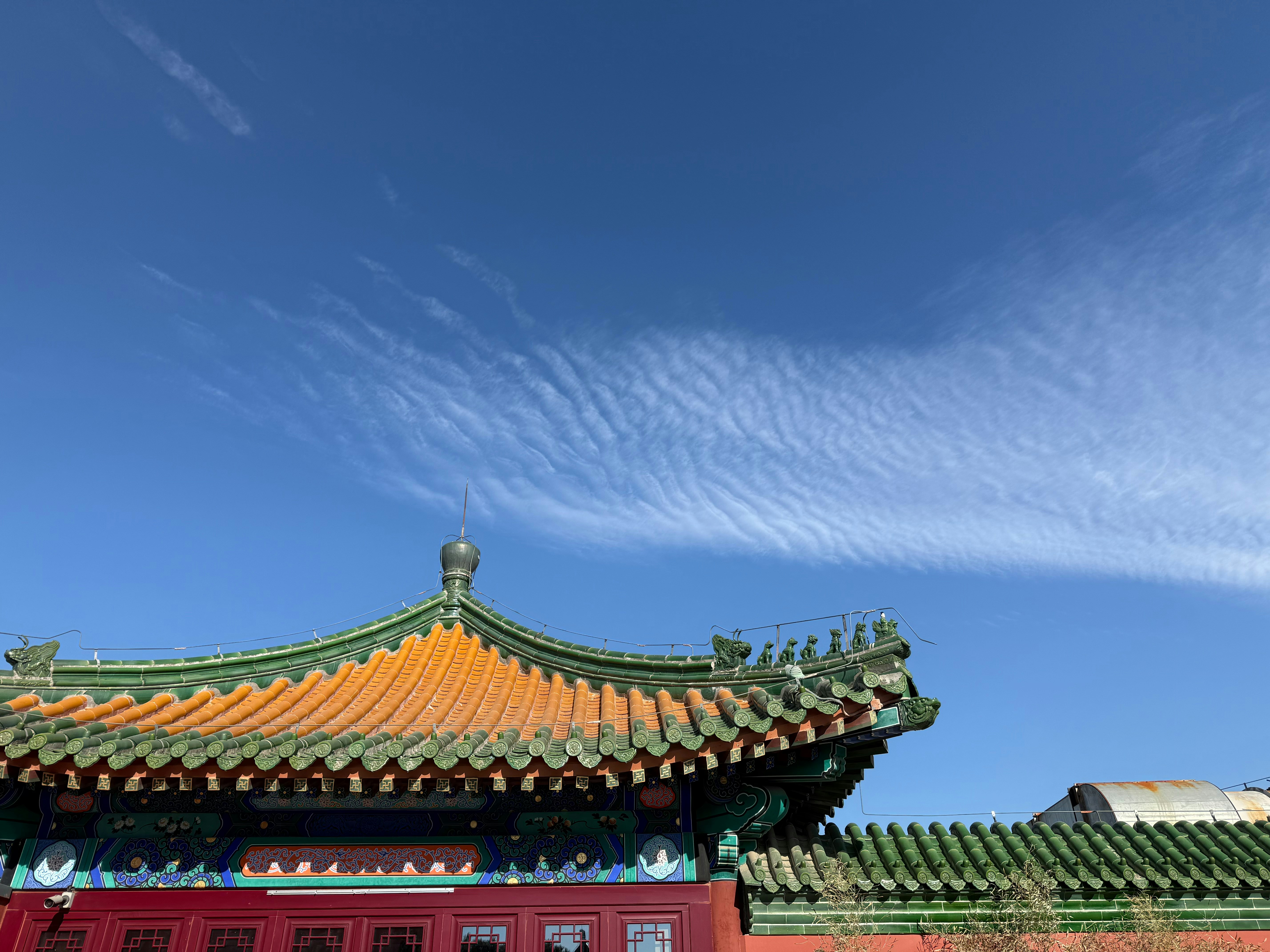 Traditional chinese temple roof against a bright blue sky
