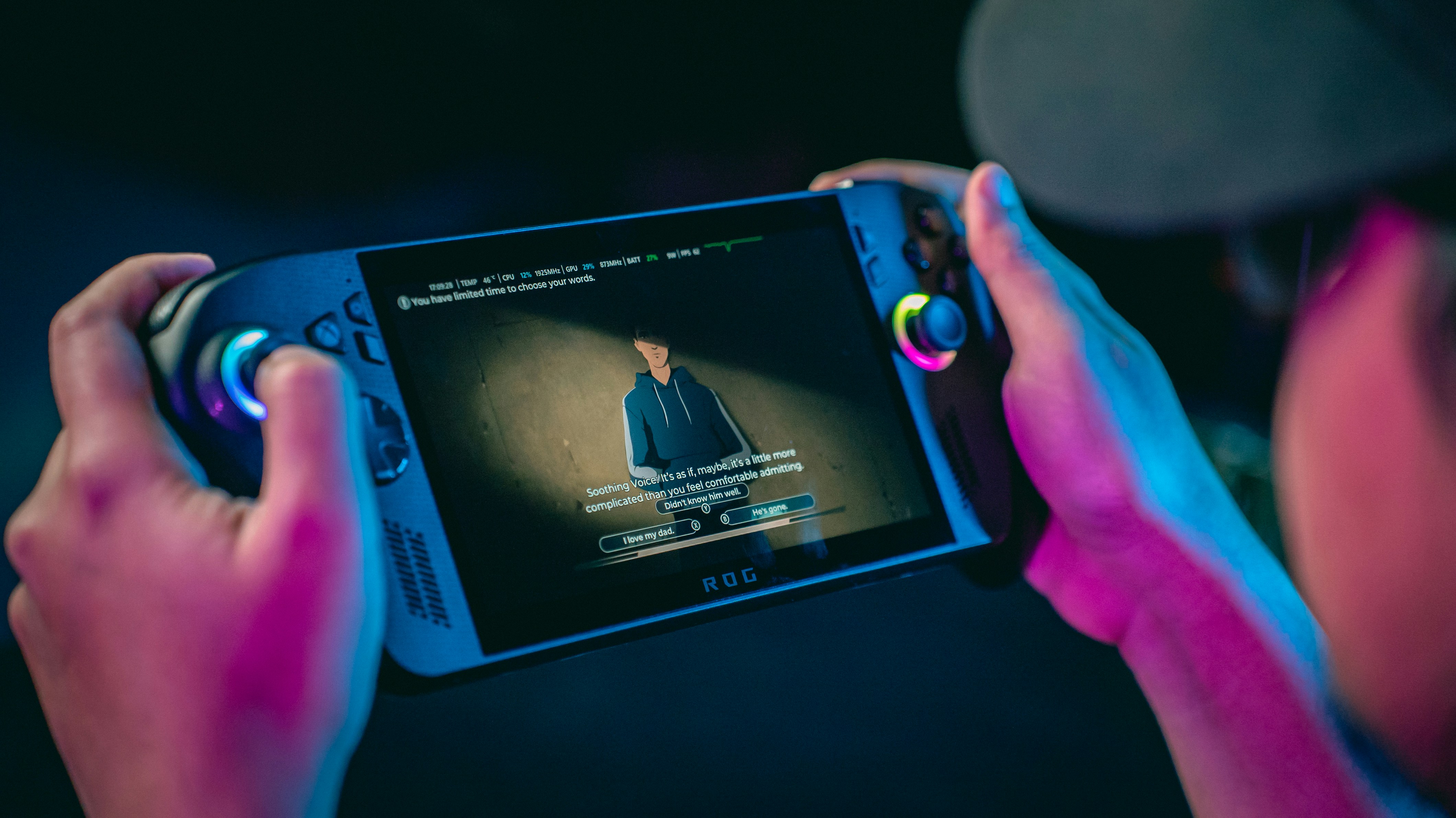Person holding a portable gaming console playing a video.