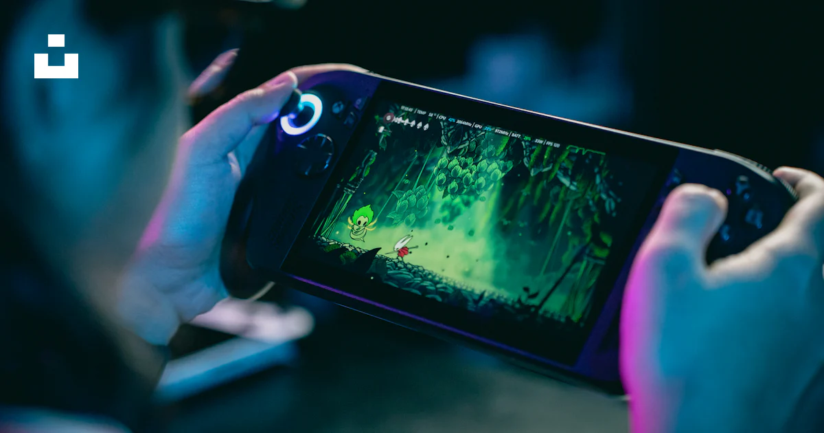 Person playing a video game on a portable console. photo – Free Gaming ...