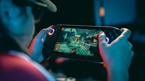 Person playing a video game on a handheld device.