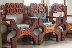 Ornate wooden bench with carved detailing and cushions