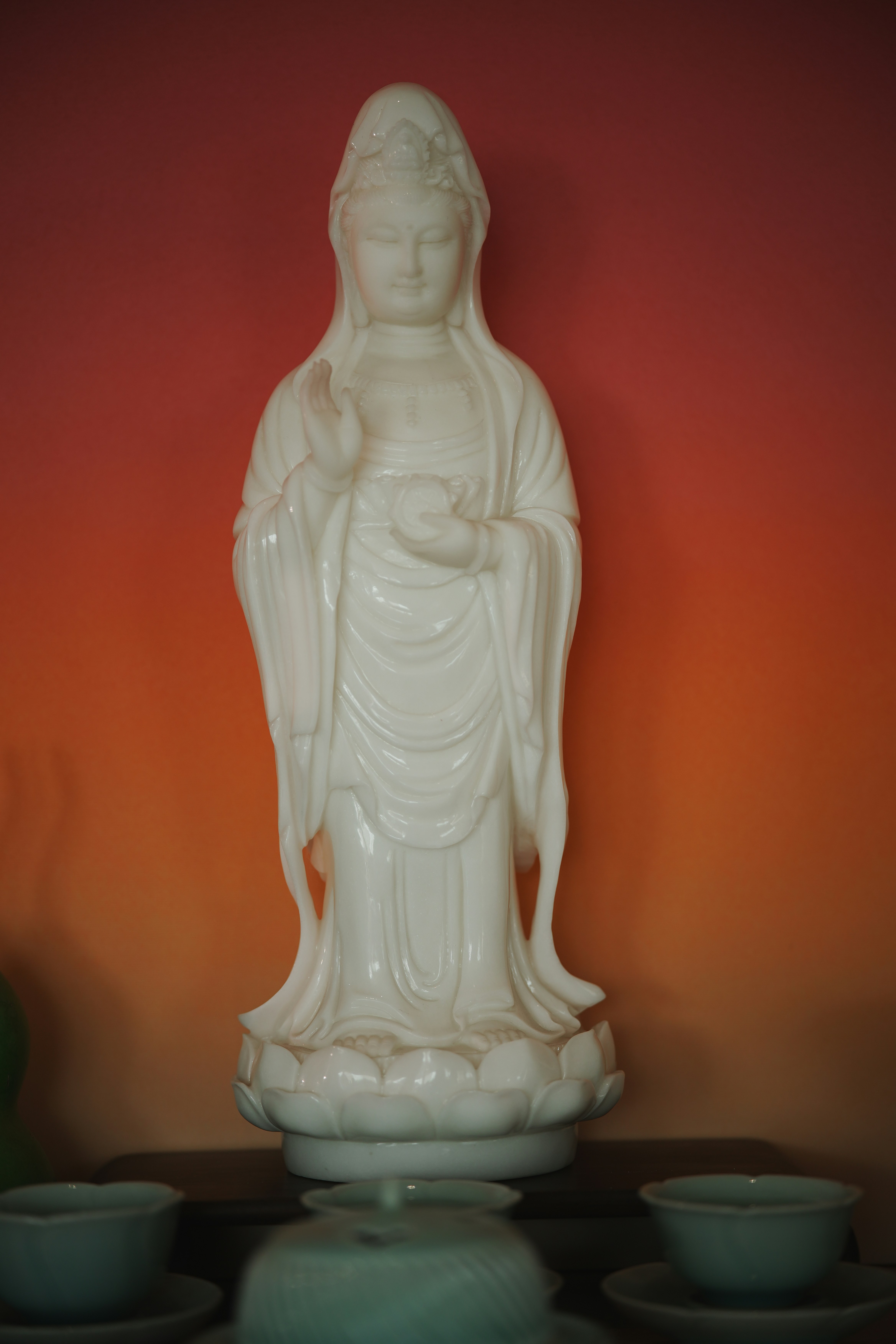 White statue of a goddess on lotus flower