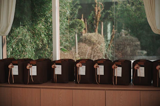 Brown bags with tags lined up on a shelf.
