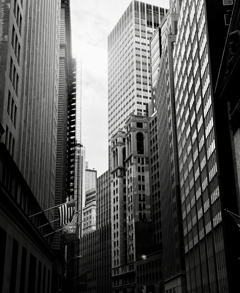 Tall buildings line a city street in the New York financial district