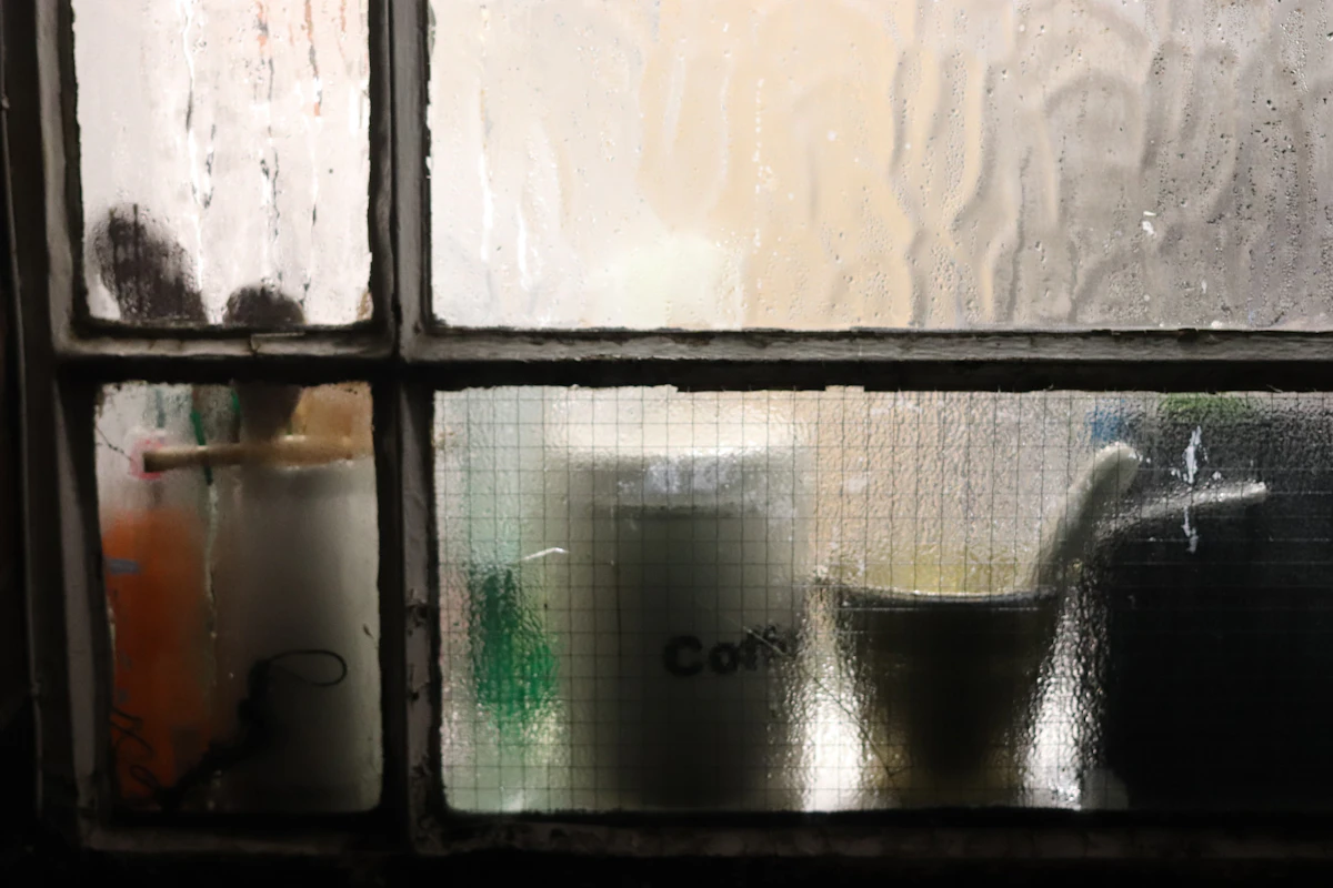 A coffee mug on a kitchen table in soft morning light by a window.