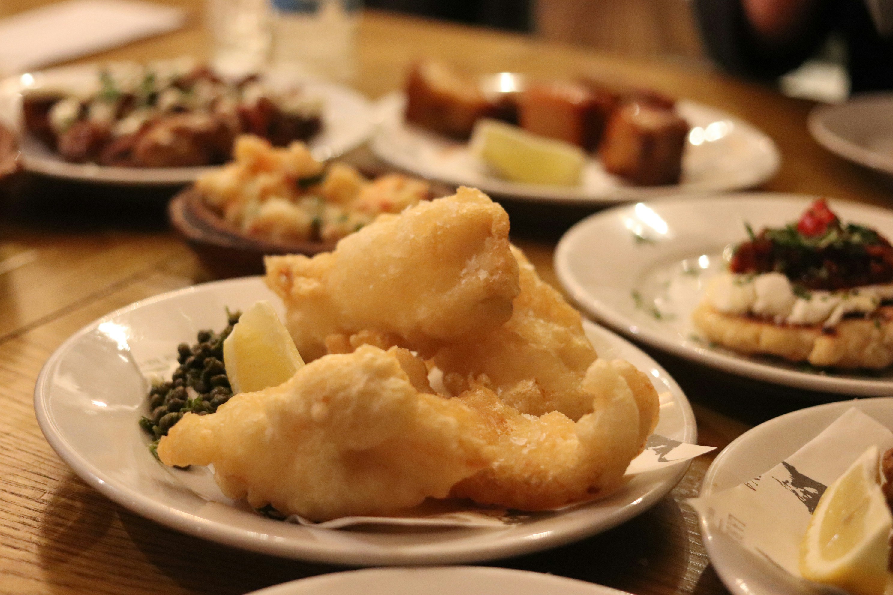 Fried fish and chips served with lemon wedges