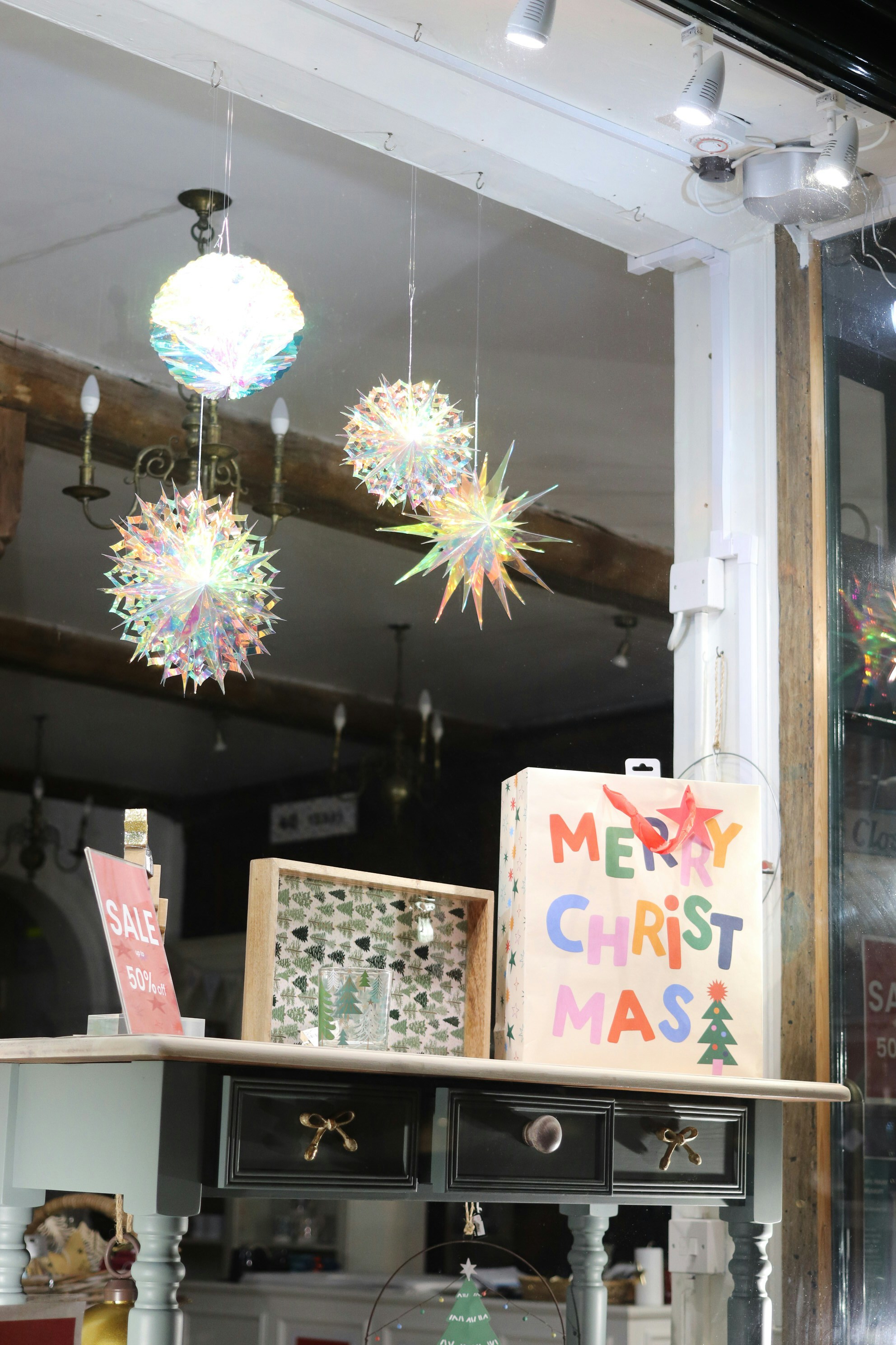 Christmas decorations and gift bag in shop window