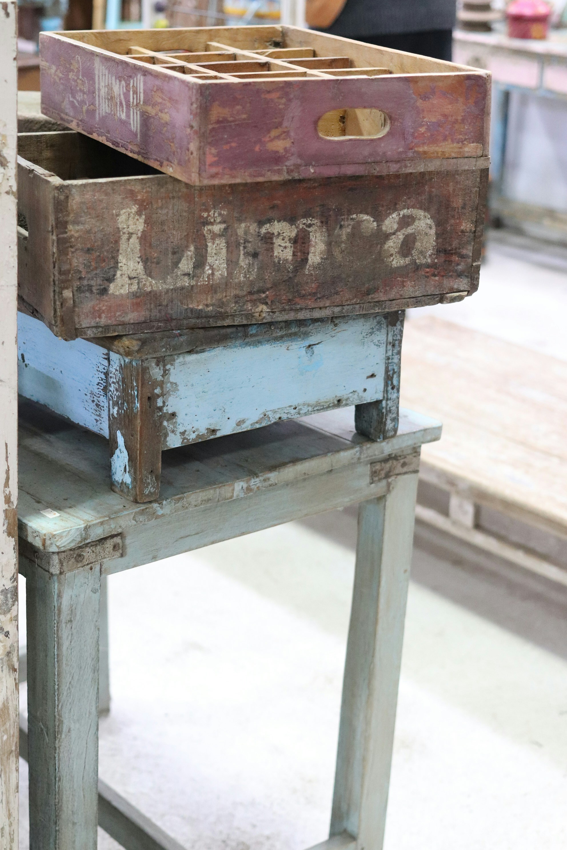 Stacked vintage wooden crates with distressed paint.