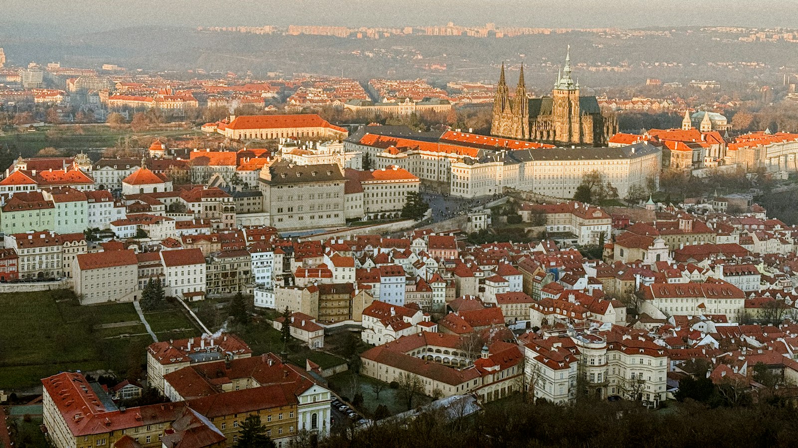 Prague Castle and St. Vitus Cathedral rising above the red rooftops of Malá Strana