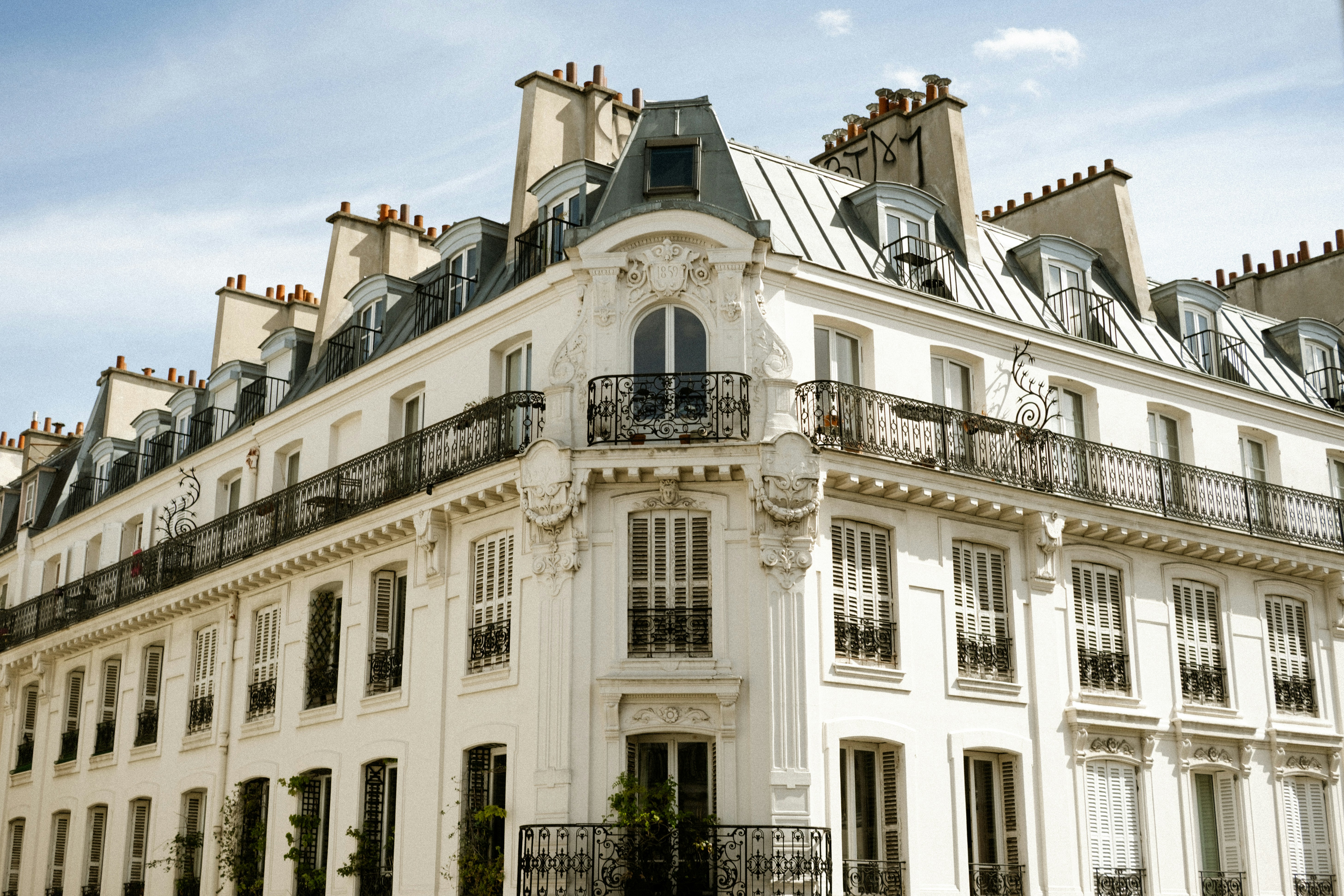 Ornate white building with mansard roof and balconies