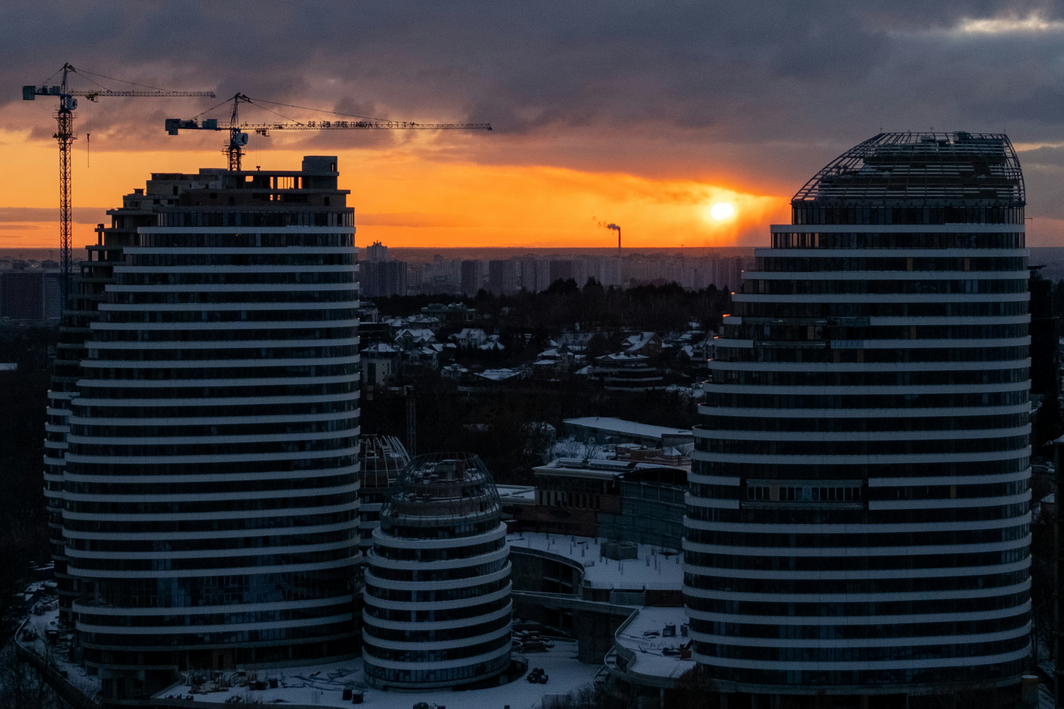 Modern buildings under construction at sunset