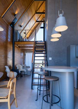 Modern interior with wooden walls and industrial staircase.