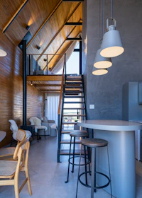 Modern interior with wooden walls and industrial staircase.