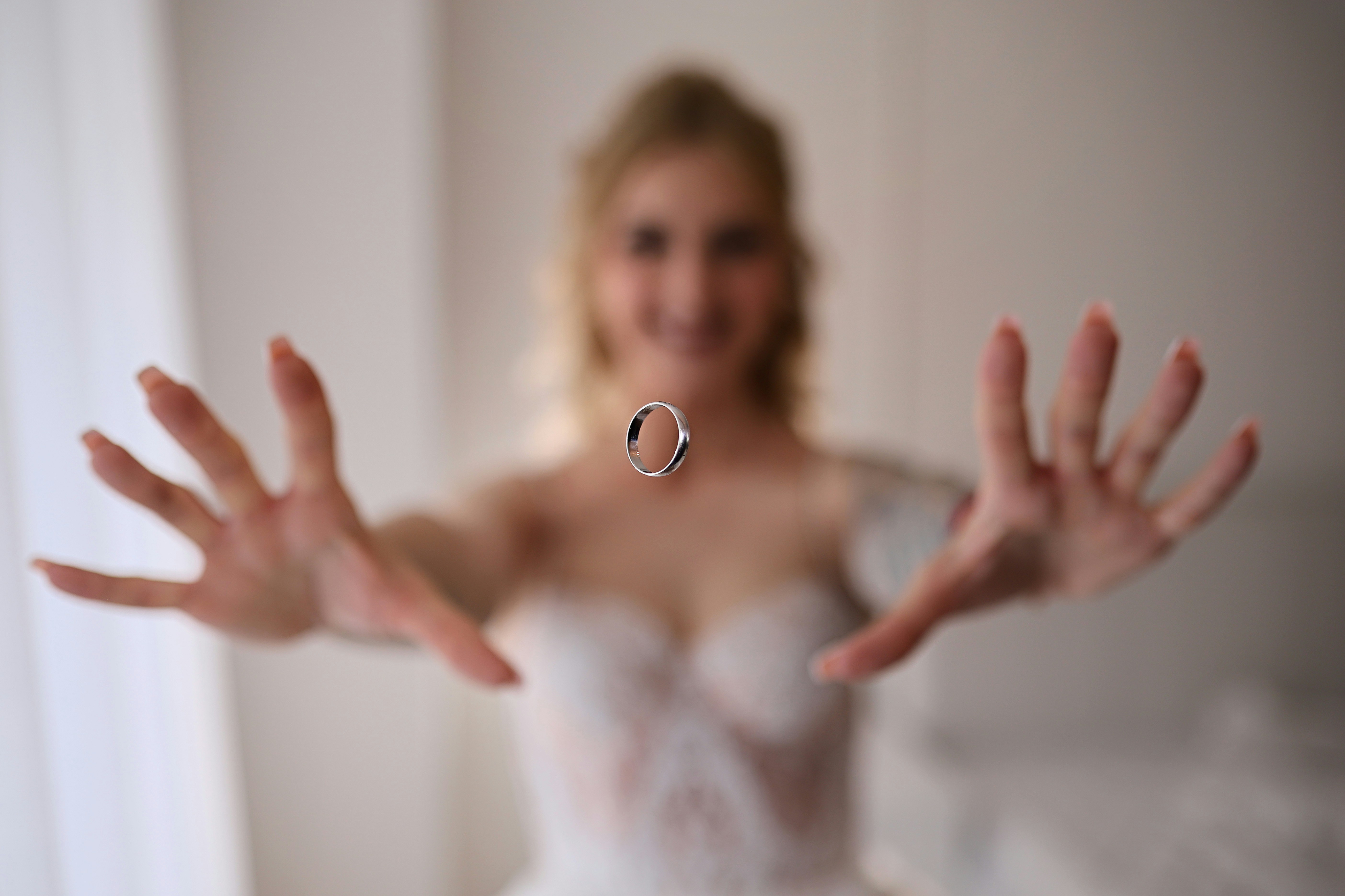 Bride tossing a wedding ring in the air