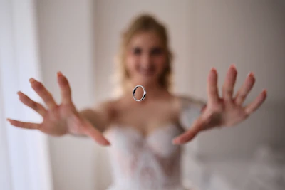 Bride tossing a wedding ring in the air