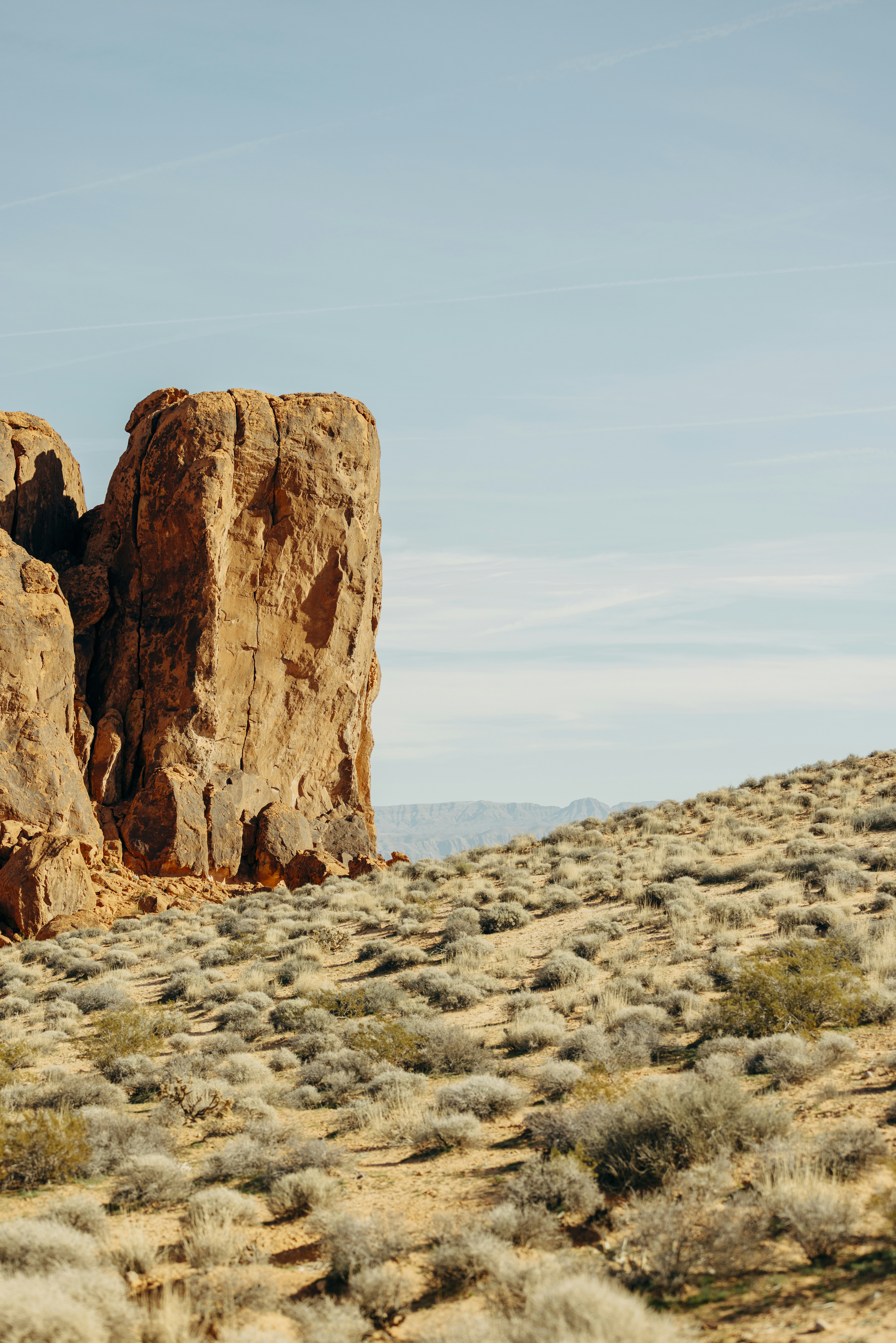 Desert landscape with sandstone rock formations and sparse vegetation