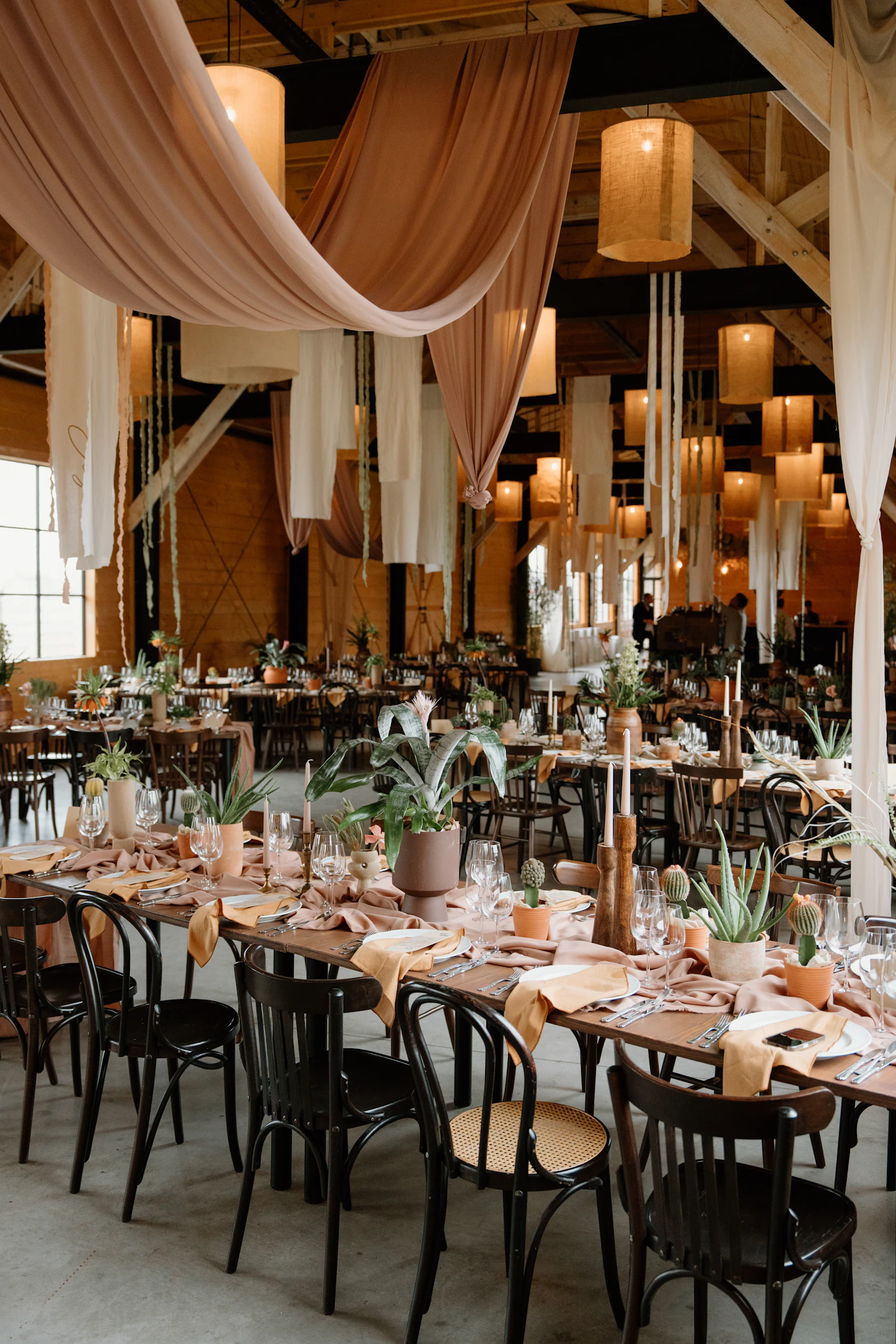 How to coordinate vendor arrival times on wedding day — A wedding coordinator reviews a clipboard timeline at the venue.