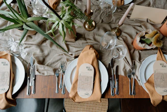 A beautifully set dining table with place settings and decor.