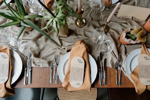 A beautifully set dining table with place settings and decor.