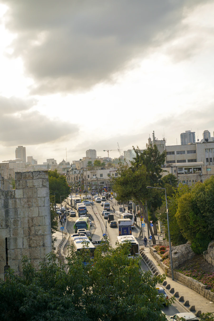 A street in Jerusalem with old stone buildings under a cloudy sky