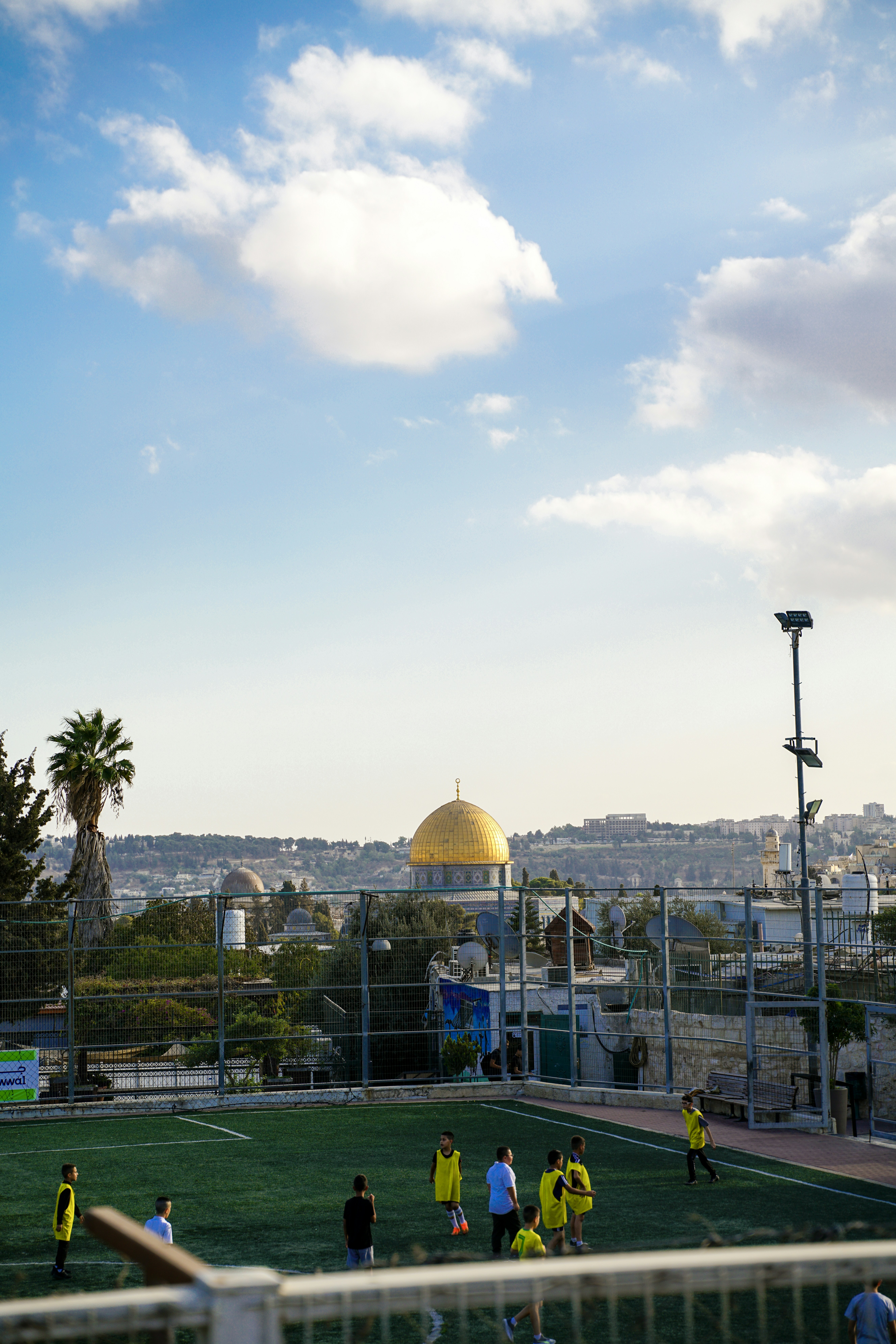 Children playing soccer with golden dome in background