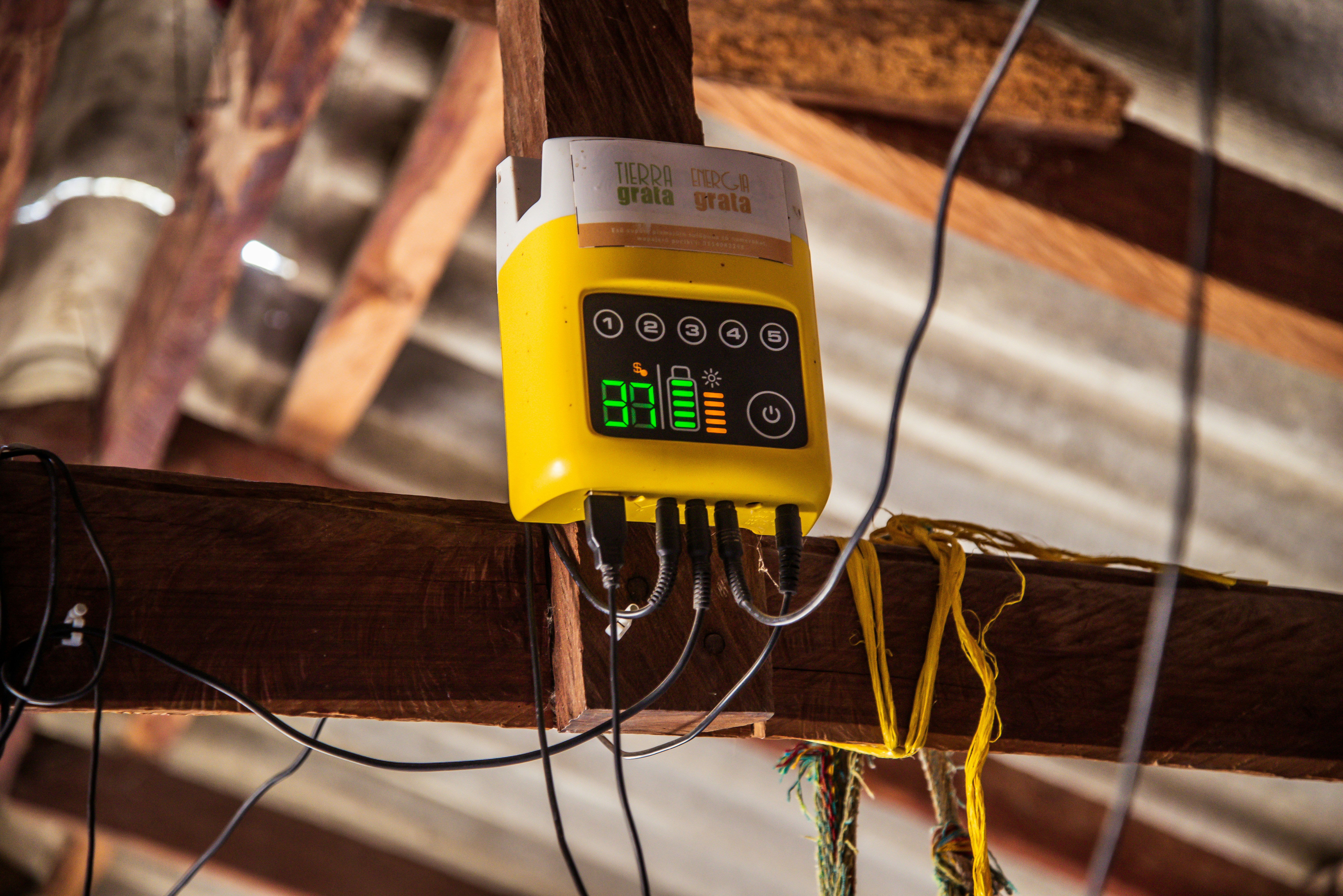 Yellow device with digital display mounted on wooden beam