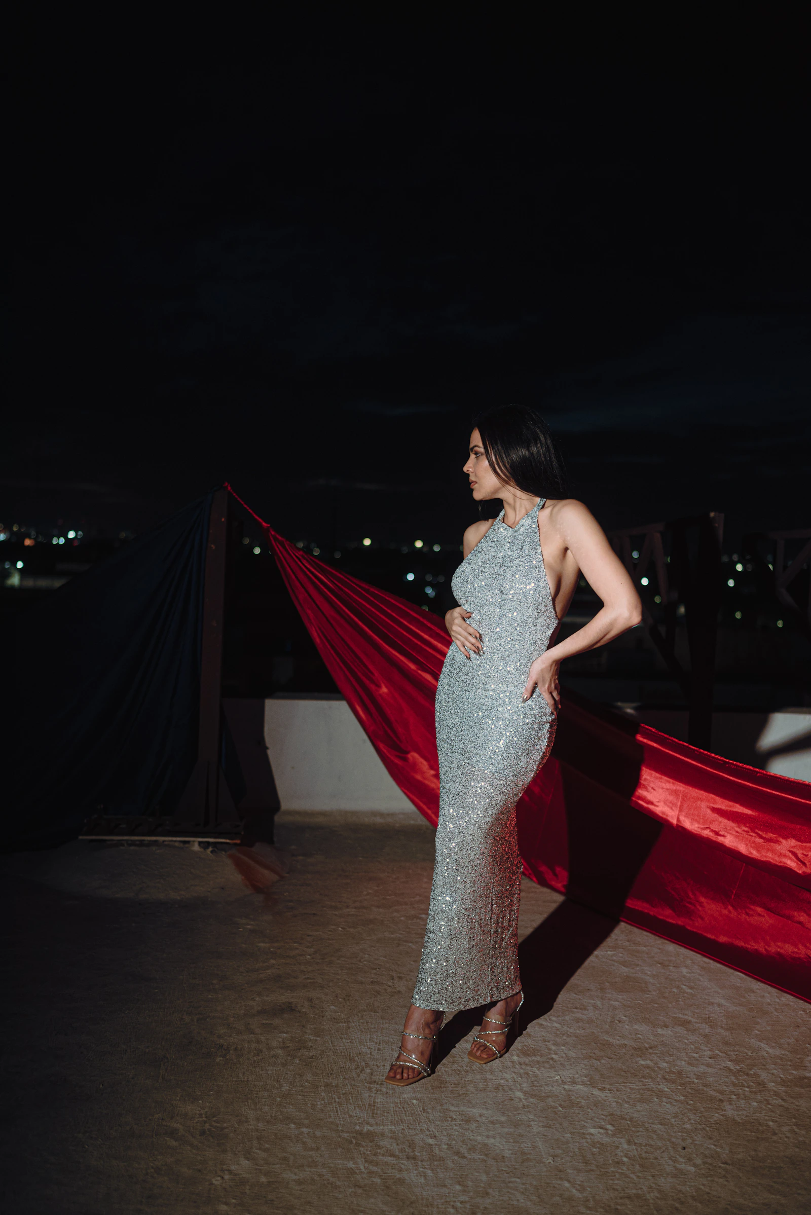 Editorial portrait of a woman wearing a shimmering evening gown