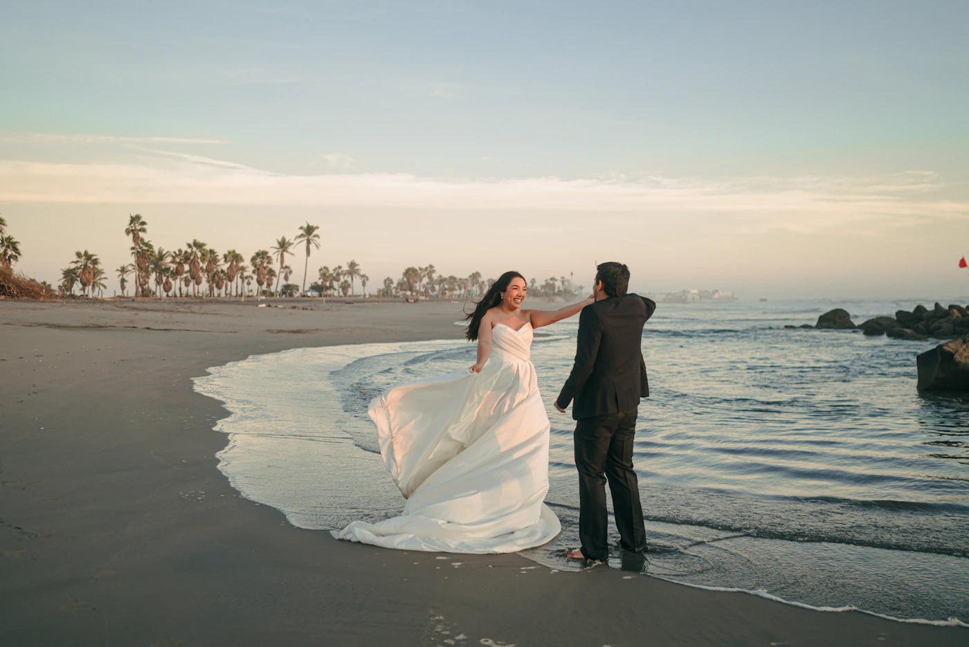 Couple during their San Andrés elopement in the dry season with the calm Caribbean water and the vivid blue sky behind them