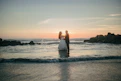 Couple dancing on a beach at sunset