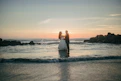 Couple dancing on a beach at sunset