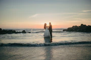 Couple dancing on a beach at sunset