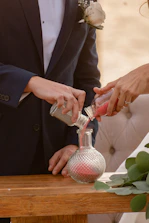 Couple performing a sand ceremony at a wedding.