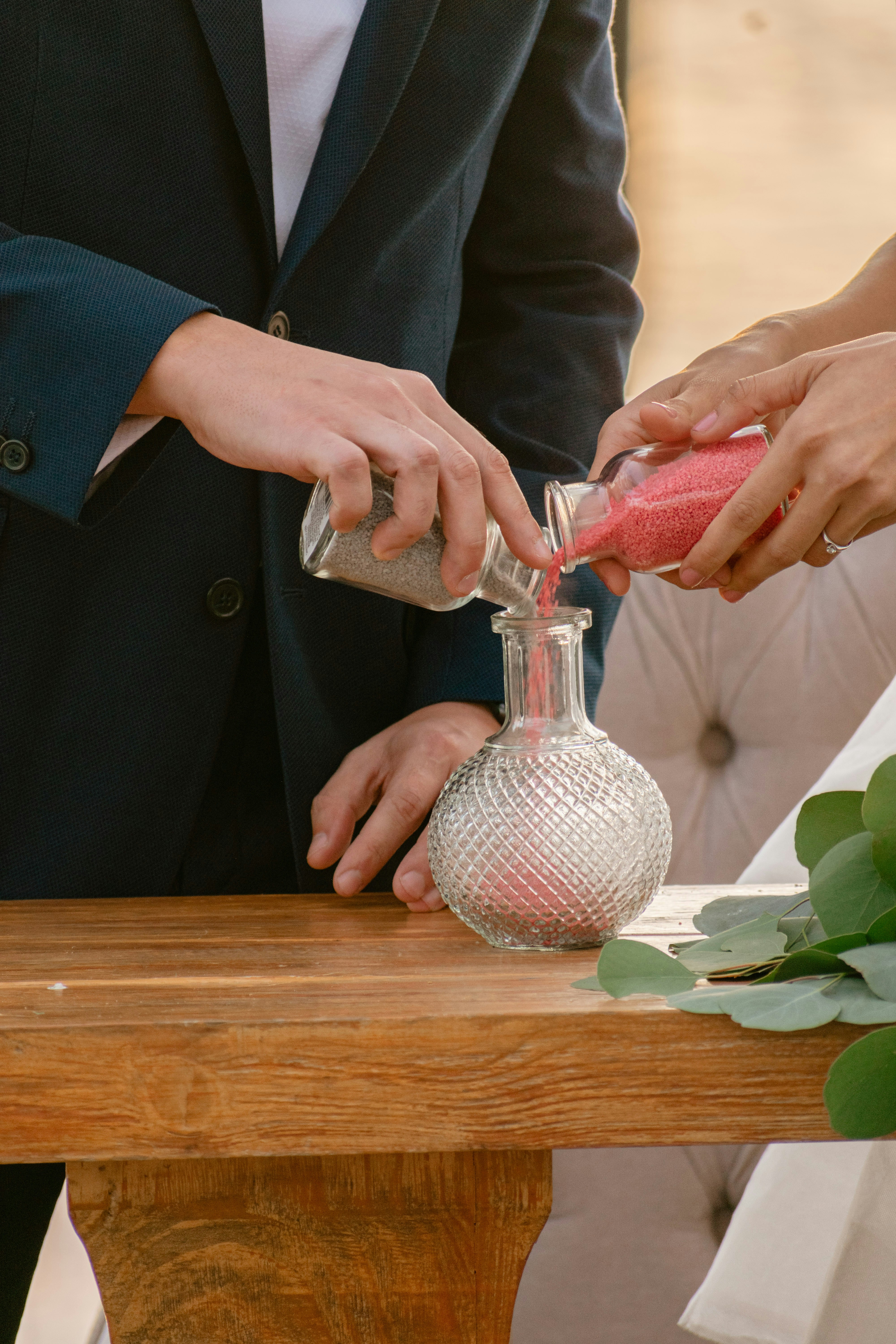 Couple pouring sand into a vase during ceremony