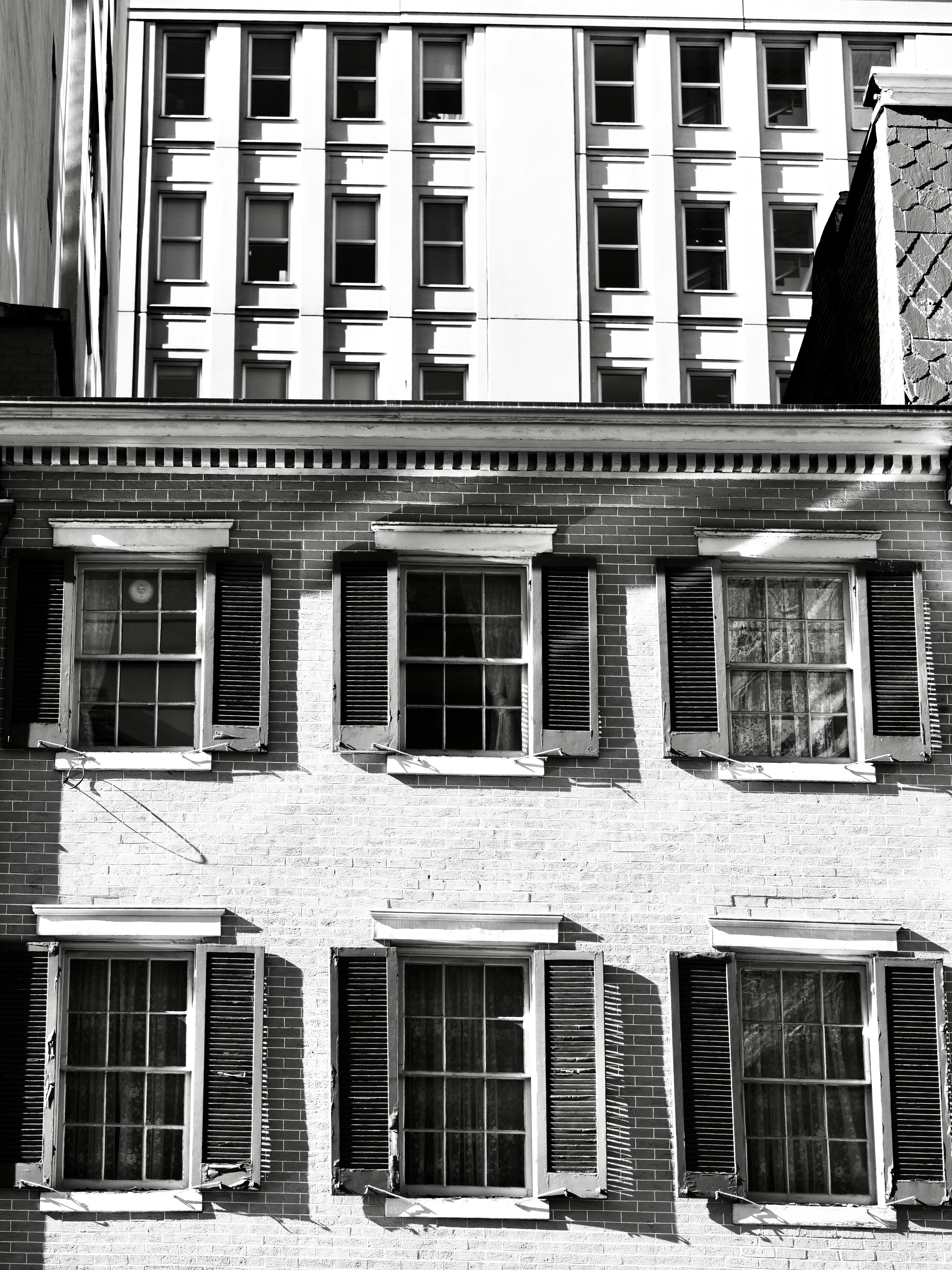 Old brick building with modern building behind