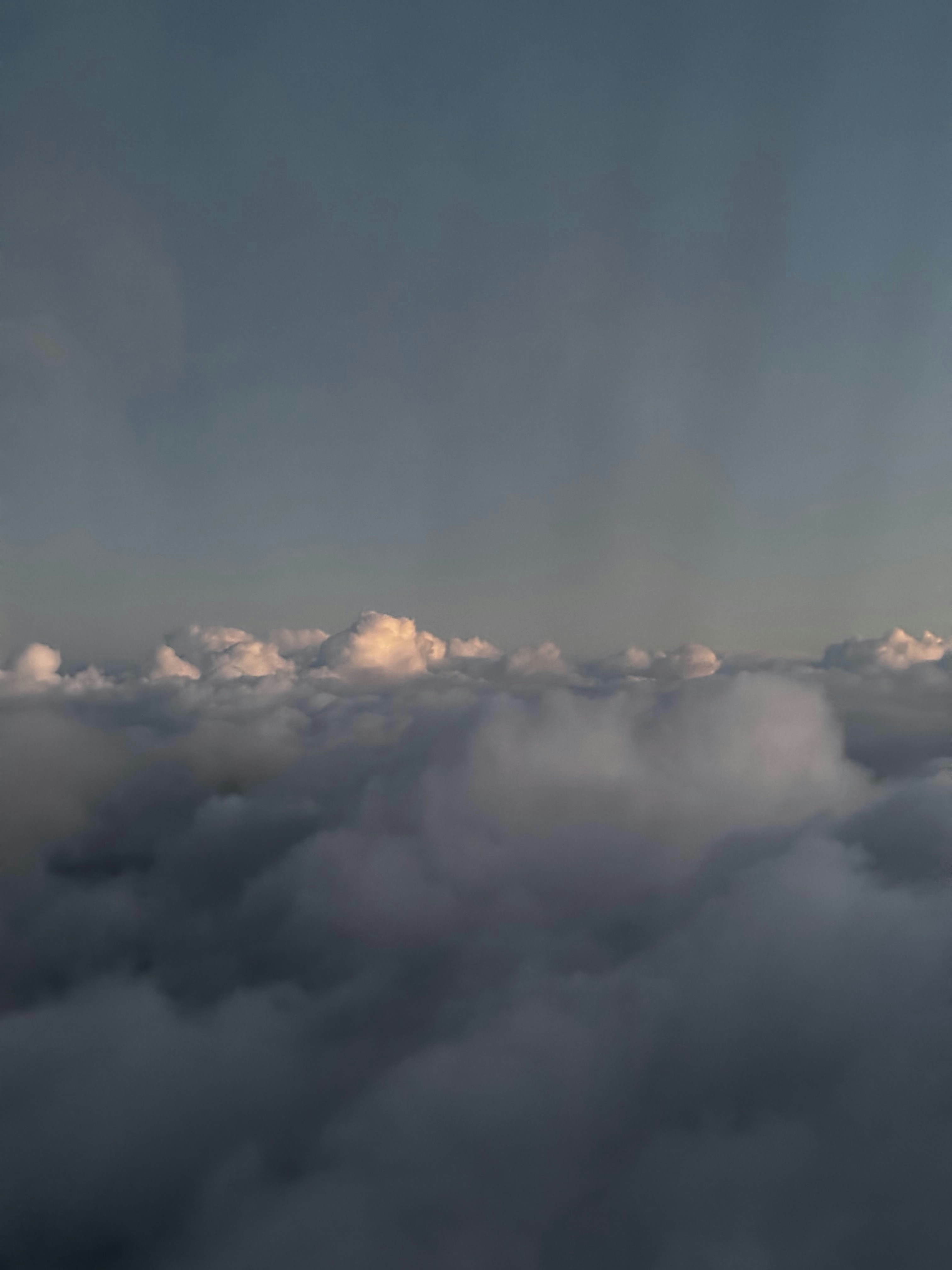 Fluffy clouds illuminated by soft sunlight at dusk.