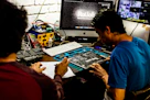 Two men working on a computer motherboard