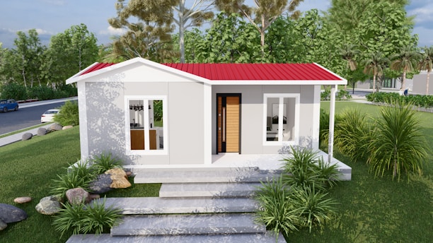 A small, modern prefabricated house with a red roof.