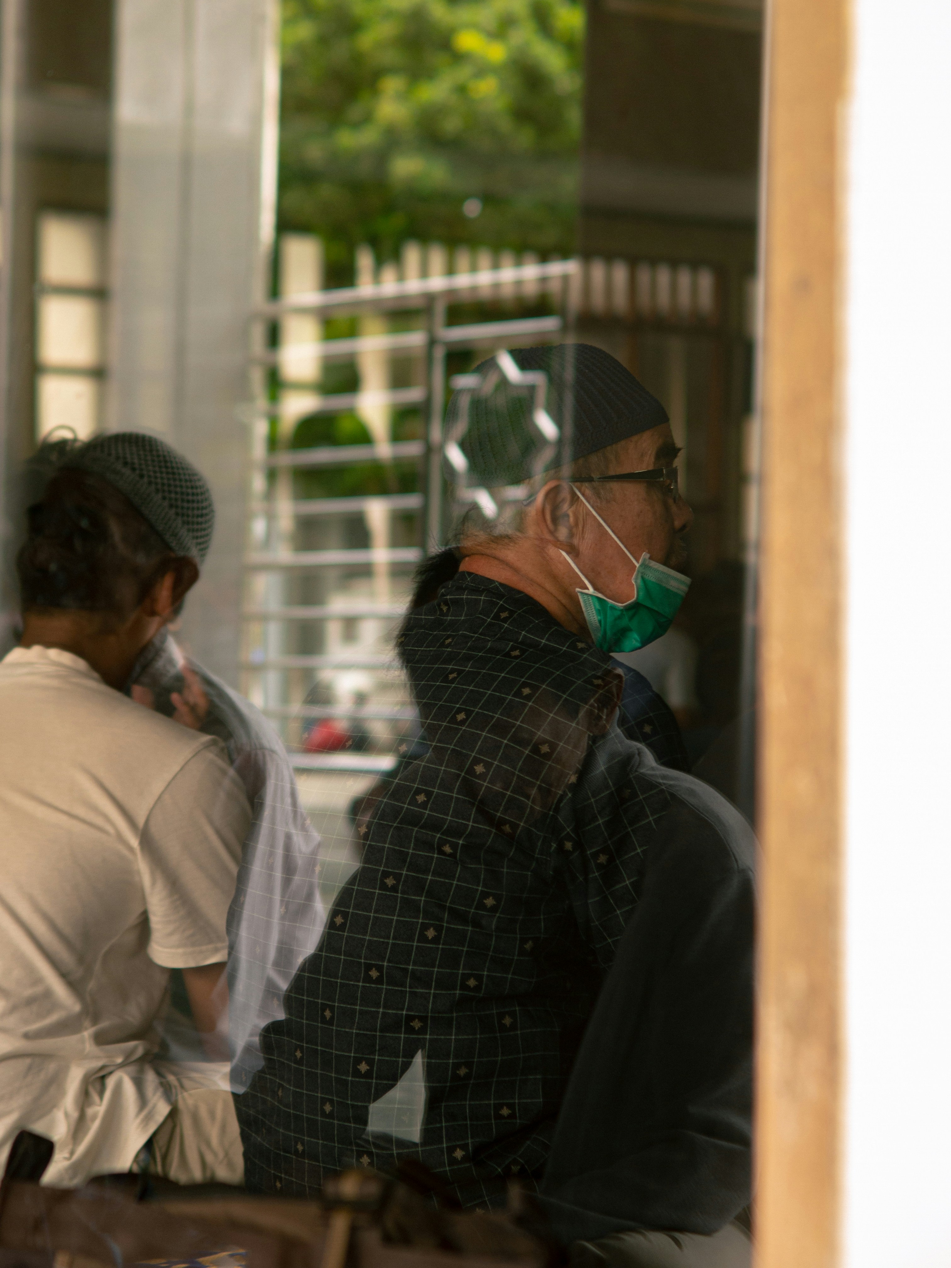 Men in prayer wearing face masks