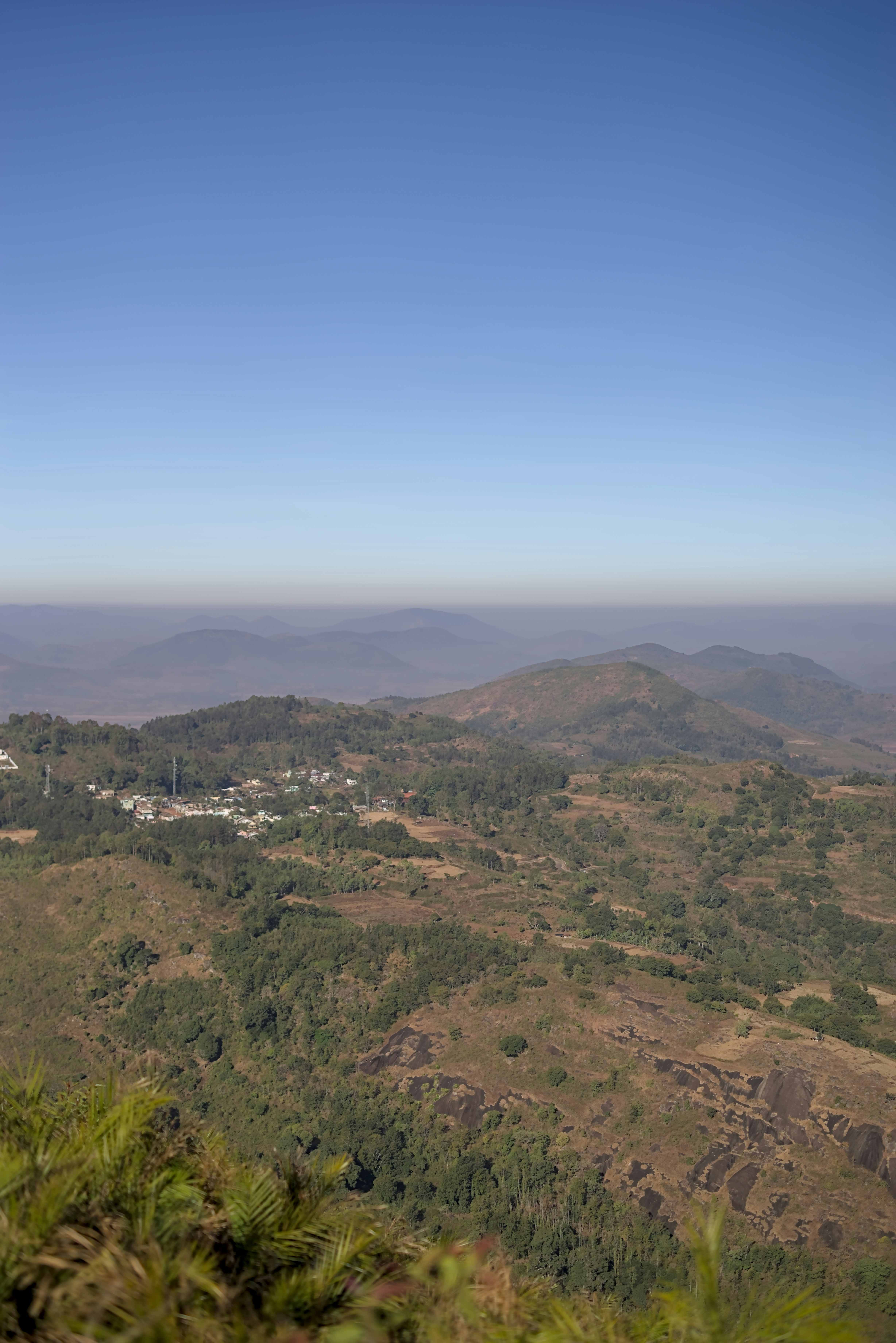 Hazy mountain landscape with a small village below.