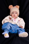 Baby wearing a cute hat and sweater with christmas-themed sweater