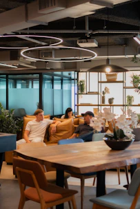 People relaxing in a modern office lounge area.