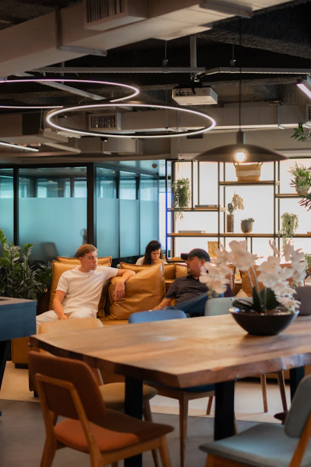 People relaxing in a modern office lounge area.