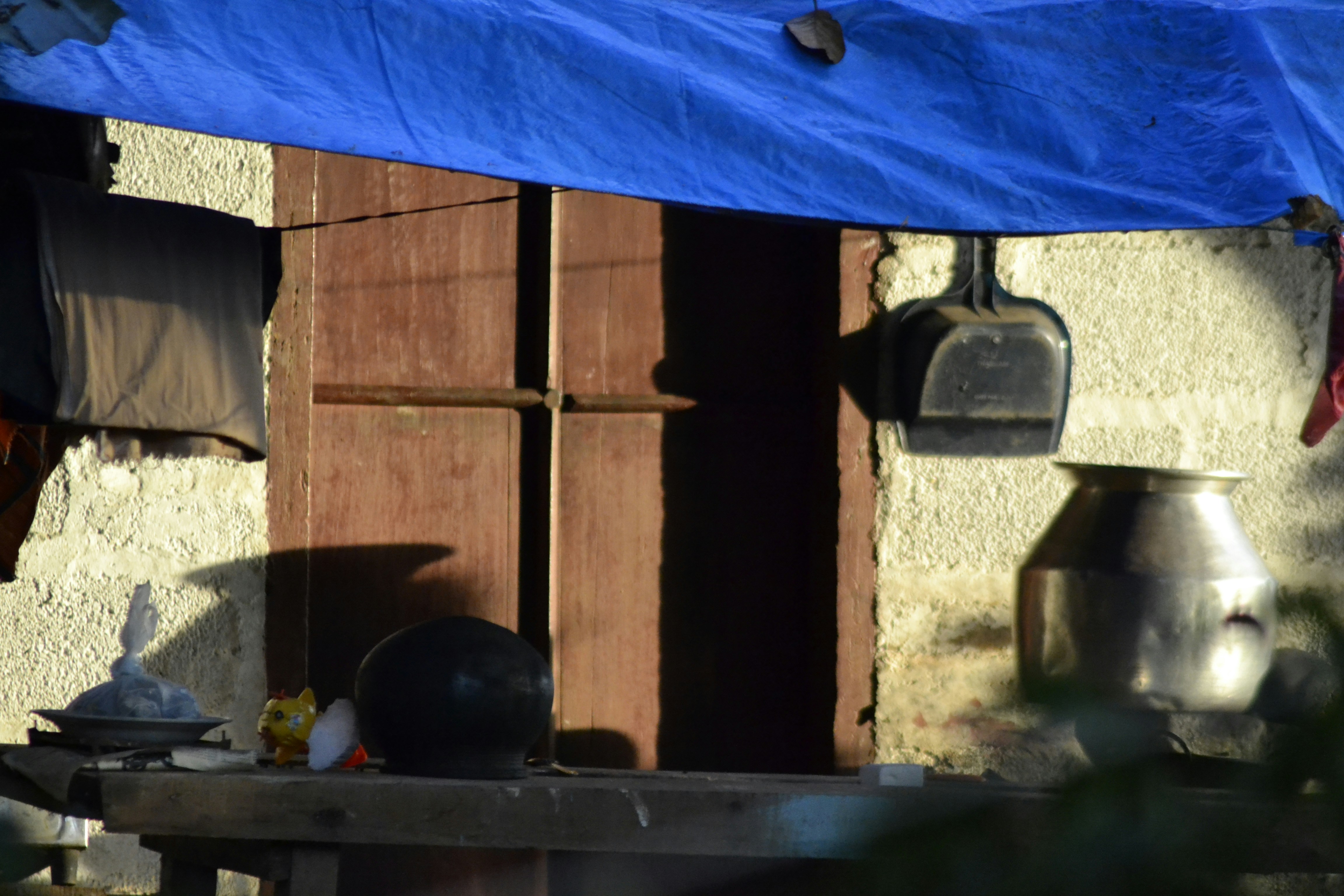 Rustic outdoor kitchen scene with pots and utensils