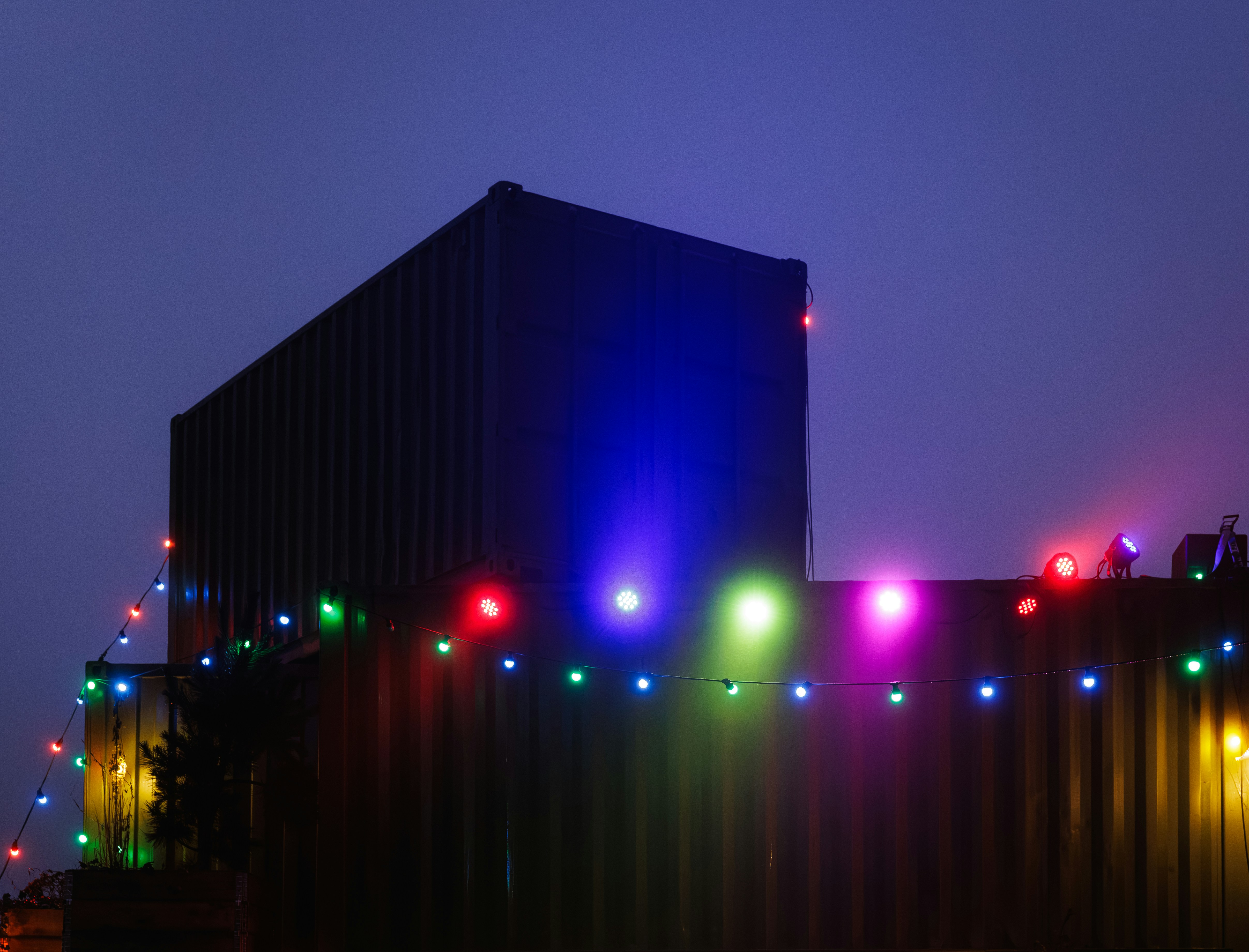Building decorated with colorful string lights at dusk