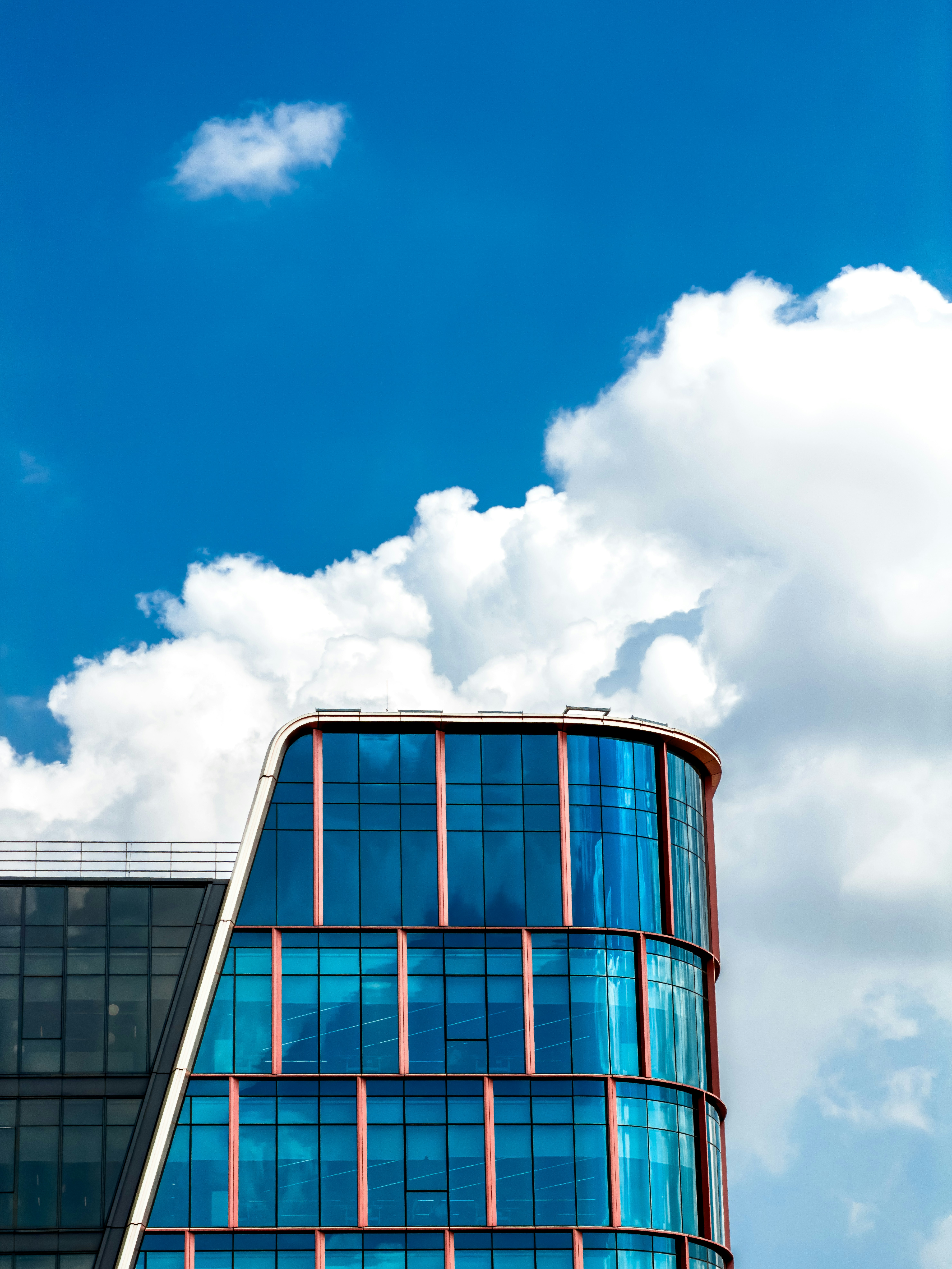 Modern glass building against a blue sky